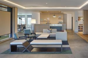 a living room with couches and tables and chairs at Hyatt House Columbus OSU Short North in Columbus