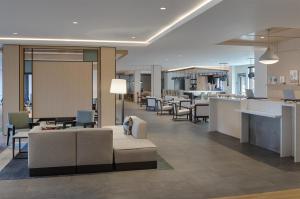 a lobby with a couch and chairs and a bar at Hyatt House Columbus OSU Short North in Columbus