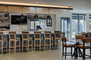 a bar in a restaurant with chairs and tables at Hyatt House Columbus OSU Short North in Columbus