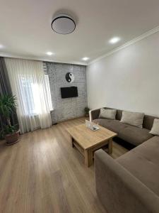 a living room with a couch and a table at Relax garden area with BBQ zone in Yerevan