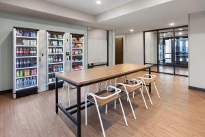 a dining room with a table and chairs and drinks at ECHO Suites Extended Stay by Wyndham Houston Katy West in Katy