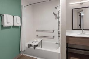 a bathroom with a shower and a sink at ECHO Suites Extended Stay by Wyndham Houston Katy West in Katy