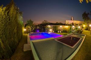 a swimming pool in a yard at night at Hotel Boutique Casa Isabella in Tepoztlán