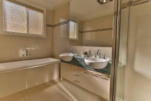 a bathroom with two sinks and a shower at Phillip Island Dream Getaway in Ventnor