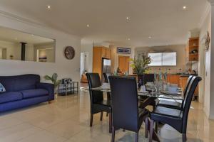 a dining room and living room with a table and chairs at Phillip Island Dream Getaway in Ventnor