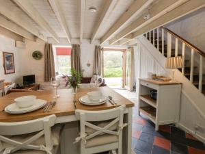 a dining room with a table and chairs at Sycamore Vestry in Fishguard