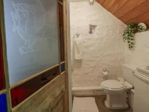 a bathroom with a toilet and a shower at Sycamore Vestry in Fishguard +15 photos