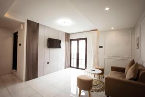 a living room with a couch and a tv at Lovia Villa Dieng in Kejajar
