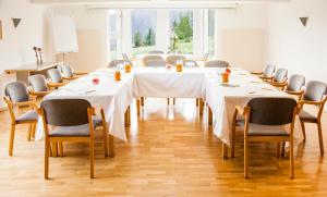 a conference room with a long table and chairs at Hotel Belmont in Imst