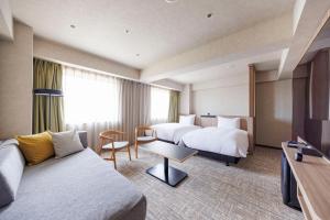 a hotel room with two beds and a couch at Richmond Hotel Nagoya Nayabashi in Nagoya +184 photos