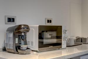 a microwave sitting on top of a kitchen counter at Studio București in Bucharest