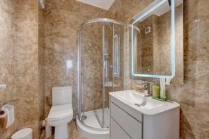 a bathroom with a toilet and a shower and a sink at Studio București in Bucharest +1 photo