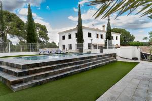 an exterior view of a house with a pool and grass at Cortijo Cristea in Cehegín