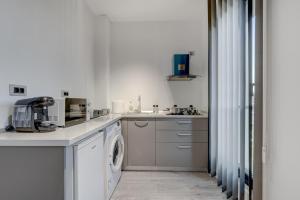 a white kitchen with a washer and dryer at Studio București in Bucharest