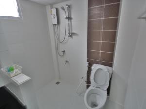 a bathroom with a shower and a toilet in it at The Bless Residence in Hat Yai