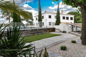 a house with a lawn in front of it at Cortijo Cristea in Cehegín