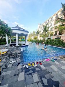 a group of people in a swimming pool with a gazebo at Villa 184 HABOBAY in Ha Long