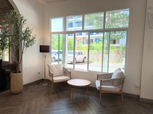 a room with chairs and a table and a window at The Bless Residence in Hat Yai