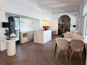 a kitchen and living room with a table and chairs at The Bless Residence in Hat Yai