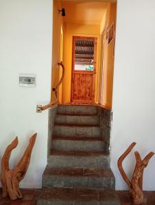 a stairway with a wooden door and some stairs at Beautiful cabin on Easter Island in Hanga Roa