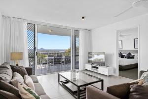a living room with a couch and a glass table at Noosa Hill Resort in Noosa Heads +174 photos