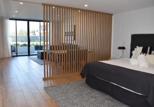 a bedroom with a bed and a chair in it at Kove Apartment - G05 in Kiama