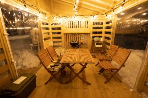 a room with a table and chairs in a cabin at yamagata glam in Murayama