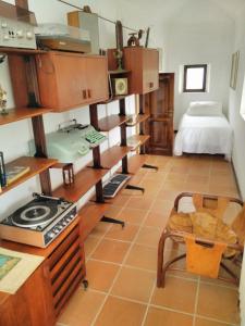a room with a kitchen and a bed in a room at Il Casino Di Mare - Dimora Storica in Santa Maria di Castellabate