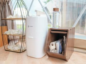 a small white refrigerator next to a bird cage at yamagata glam in Murayama