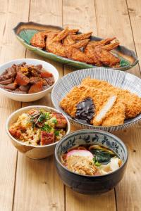 four bowls of food on a wooden table at Richmond Hotel Nagoya Nayabashi in Nagoya