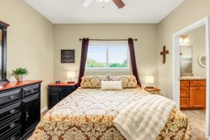 a bedroom with a bed with a window and a sink at Cliffside Paradise Waterfront in New Braunfels