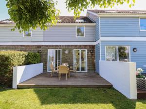 a house with a deck with a table and chairs at Delaware M2 in Yarmouth