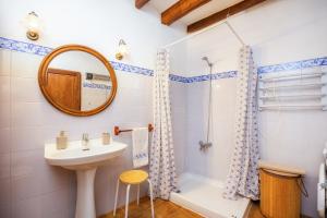 a bathroom with a sink and a shower and a mirror at Ca Sa Padrina Banyalbufar in Banyalbufar +19 photos