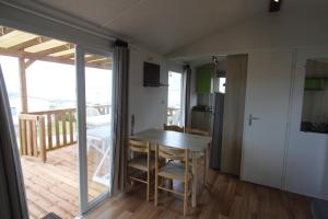 a small dining room with a table and a balcony at Blueportel Horizon L40 in Le Portel +28 photos