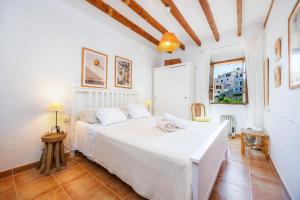 a bedroom with two beds in a room at Ca Sa Padrina Banyalbufar in Banyalbufar