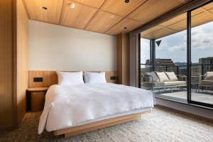 a bedroom with a large bed and a balcony at KIORI Hotel Teramachi in Kyoto
