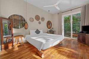 a bedroom with a bed and a television in it at Lea's Garden in An Bàn (2) +24 photos