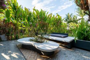 two beds sitting on the ground in a garden at Lea's Garden in An Bàn (2)