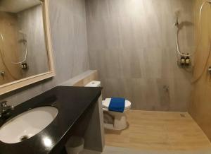 a bathroom with a sink and a toilet and a mirror at Karon Living Room - SHA Plus in Karon Beach +71 photos