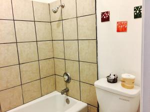 a bathroom with a toilet and a shower and a sink at Maple Inn and Suites Los Banos in Los Banos +25 photos