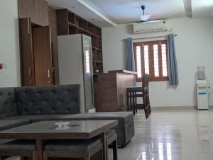 a living room with a couch and a table at Karmawas House in Jodhpur +9 photos