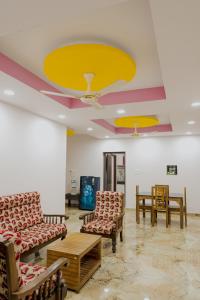a waiting room with chairs and a yellow ceiling at Varkala Escape Resort in Varkala