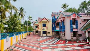 a row of colorful houses on a street at Varkala Escape Resort in Varkala