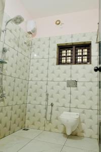 a bathroom with a shower and a toilet at Varkala Escape Resort in Varkala +20 photos