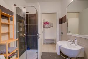 a bathroom with a sink and a shower at Lenni Apart. Swimming Pool and lake + WIFI - Happy Rentals in Leggiuno