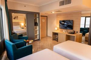 a living room with a room with a bedroom at Majestic Central Hotel in Dubai