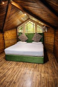 a bedroom with a large bed in a small room at Lidder view resort in Muski