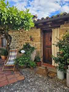 a cat laying on the ground in front of a house at El Atalanto in Madrigal de la Vera
