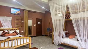 a room with two bunk beds and a television at Forest Rawana homestay Ella in Ella