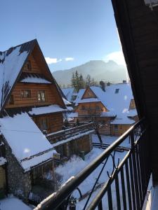 a view from a balcony of a snow covered village at Apartament Centrum Zamoyskiego in Zakopane